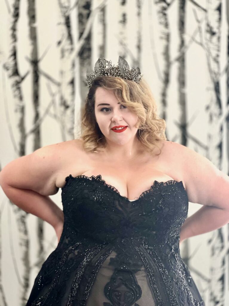 Plus Size Bride to be wearing a sleeveless, sweetheart neckline, black wedding dress and matching tiara.