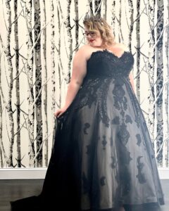 Black Wedding Dress From Mirror Mirror Bridal Boutique In Baldwinsville, NY: Dress is sleeveless with a sweetheart neckline and lace bodice. The skirt is full and has a white underlayer with black lace appliques.