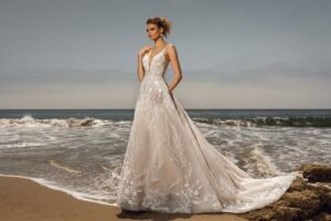 Wedding Dress Kat by Kitty Chen Couture: Dress has spaghetti straps and a plunging neckline and a luscious lace skirt with a train.