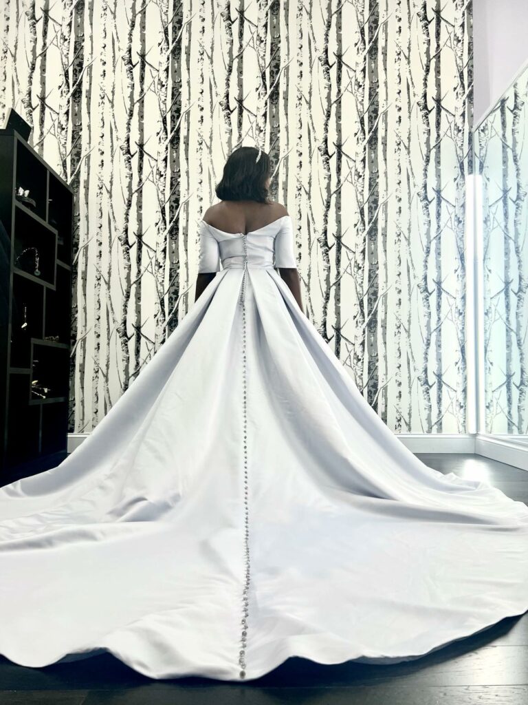 Lovely princess ballgown wedding dress being modeled by Bride to Be to show off the cathedral length train.