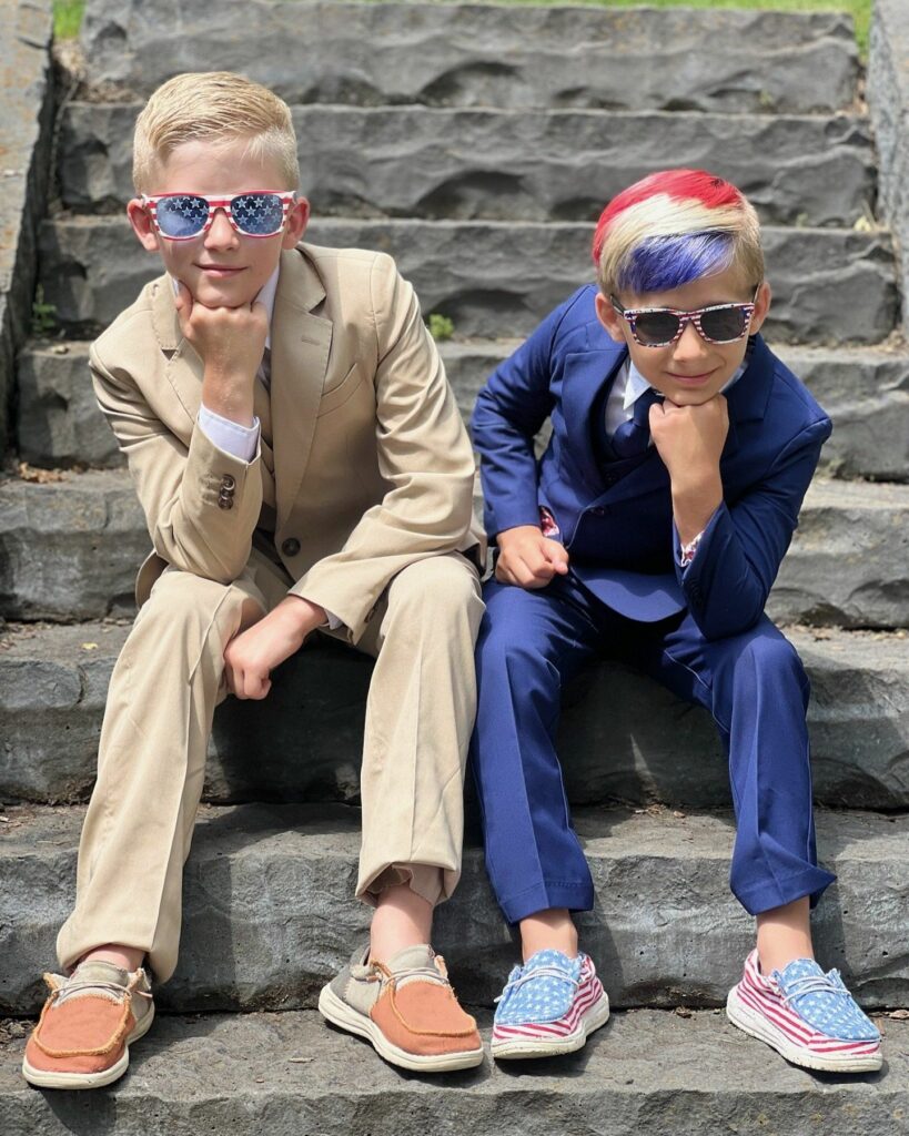 Two cool kids wearing USA colored kids tuxedos.